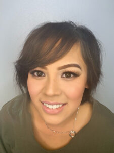 A woman with short brown hair smiling for the camera.