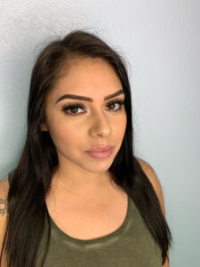 A woman with long black hair posing for a photo.