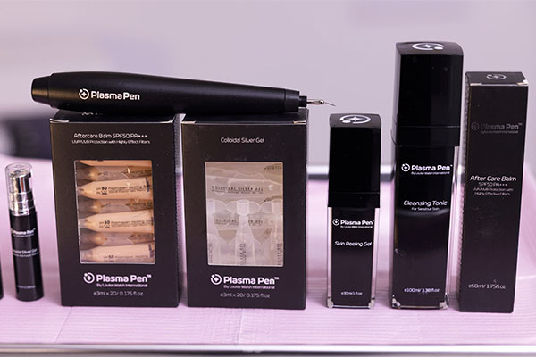 plasma-pen-product-line-600 - Elmira Studio A group of cosmetic products on a table.