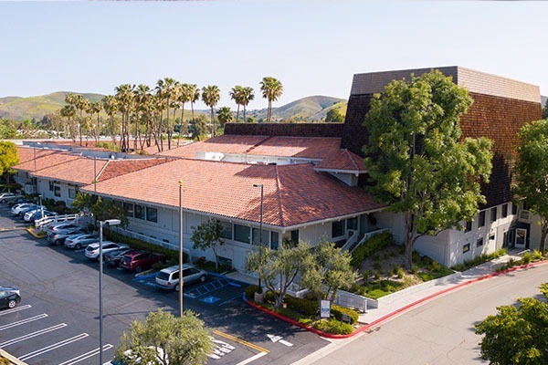 water-court-arial - Elmira Studio An aerial view of an office building with a parking lot.