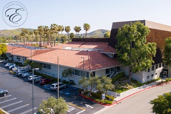 water-court-arial-2 - Elmira Studio An aerial view of a building with a parking lot.
