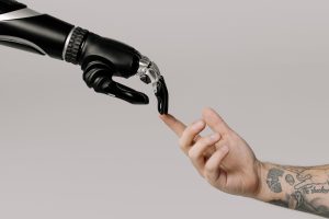 pexels-cottonbro-studio-6153354 - Elmira Studio Photo by cottonbro studio: https://www.pexels.com/photo/bionic-hand-and-human-hand-finger-pointing-6153354/